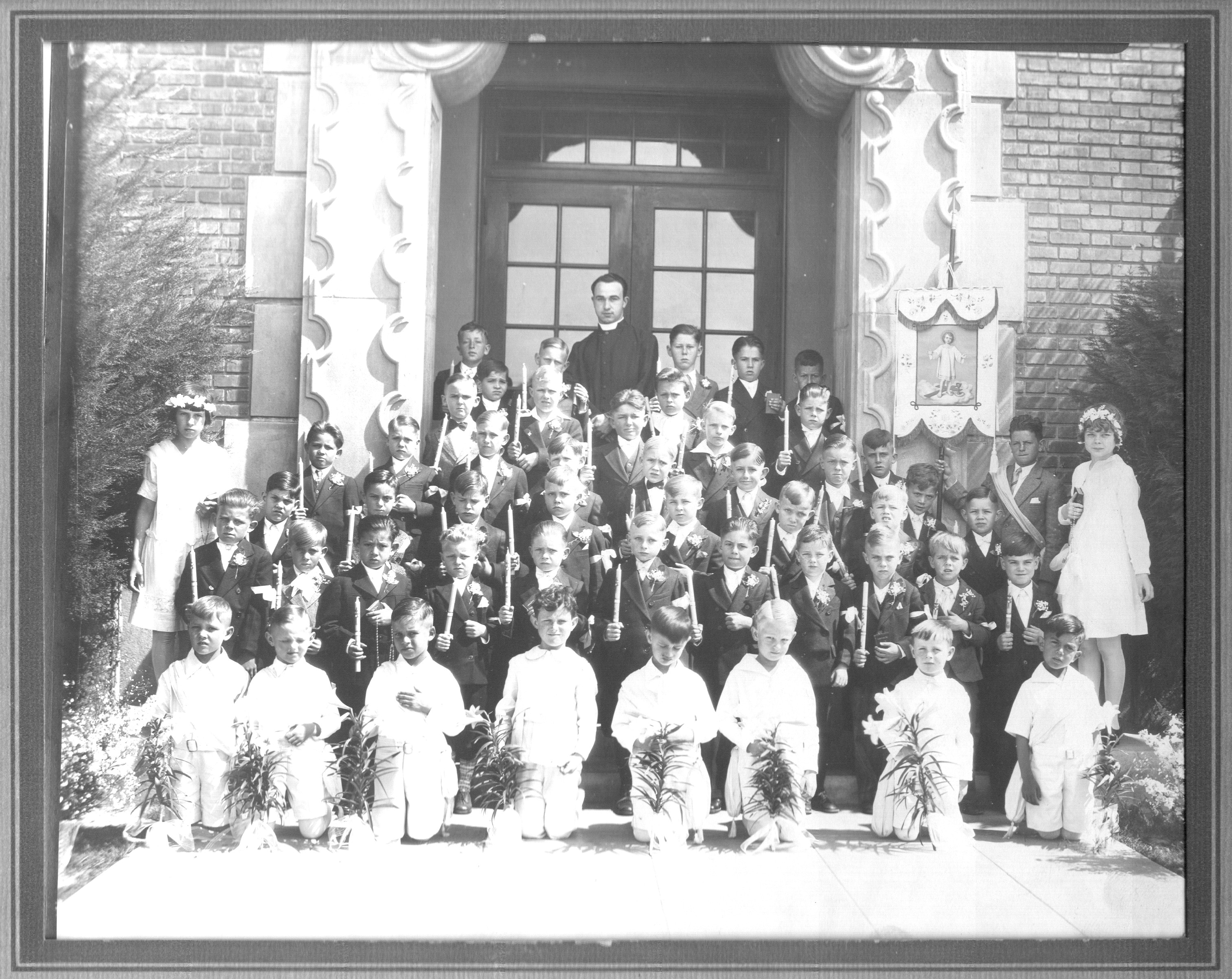 Jack Edward Wagner's First Holy Communion.  The Communicants are in the back row and the Angels are in white, in the front row.  Look at the kid, third from the left, hand over his heart, very devout and quiet.  The picture was taken on the entrance steps of St. Michaels Grammar School, in South West Los Angeles, About the 1200 block of 87th Street at Vermont Avenue.  Jack was six years old.